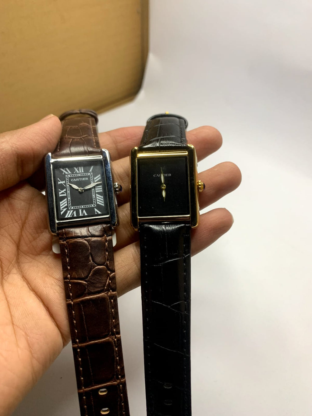 *Cartier Tank* watch featuring a rectangular steel case,