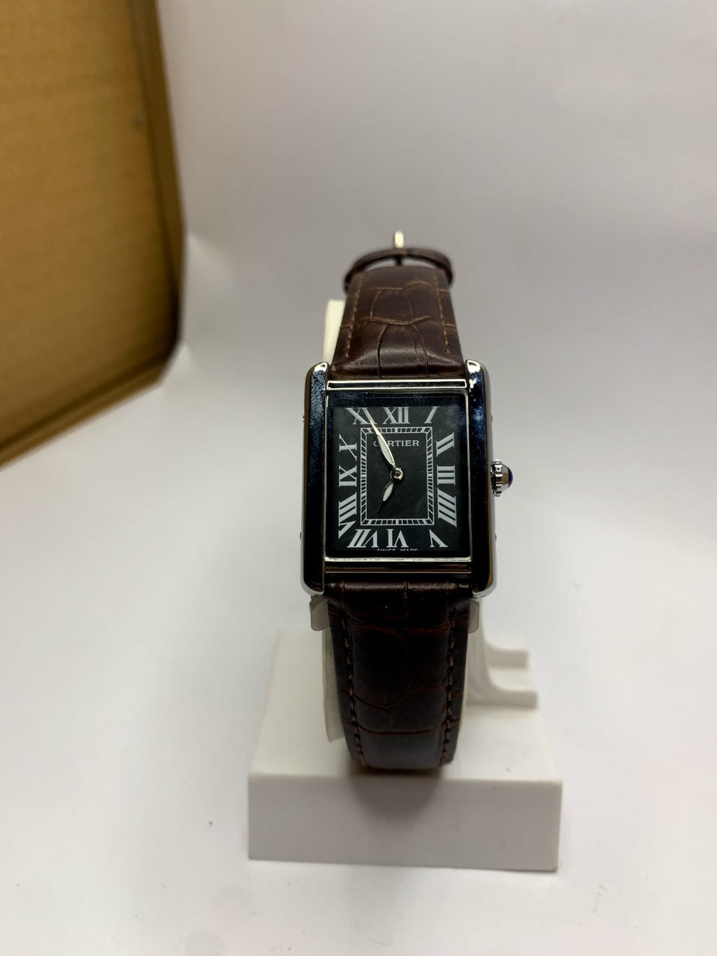 *Cartier Tank* watch featuring a rectangular steel case,