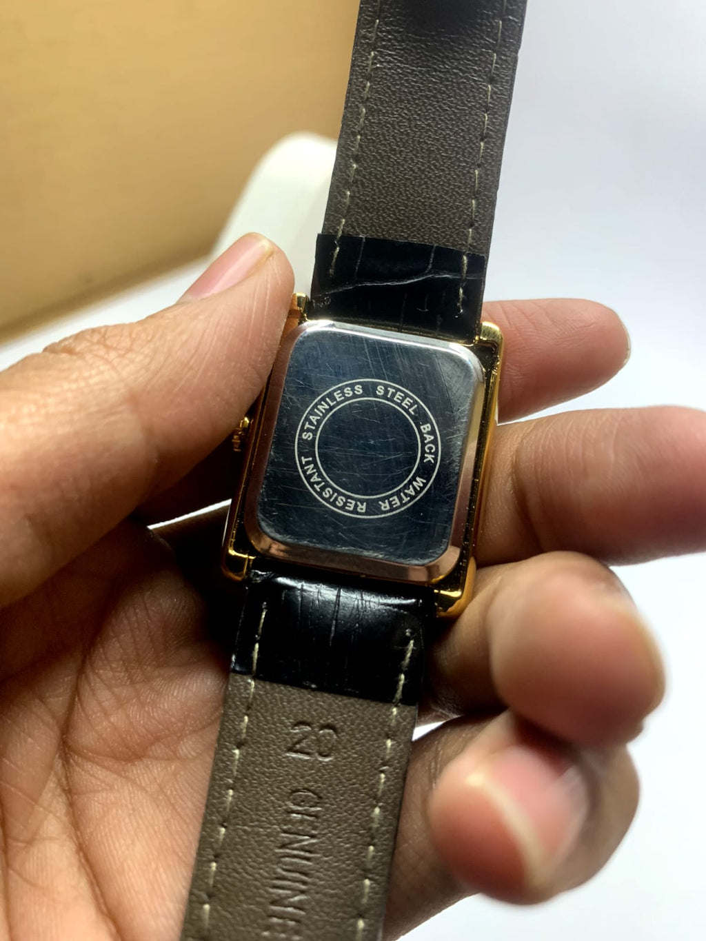 *Cartier Tank* watch featuring a rectangular steel case,